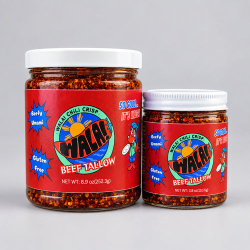 Two Wala! Beef Tallow Chili Crisp jars with red labels on a wooden surface